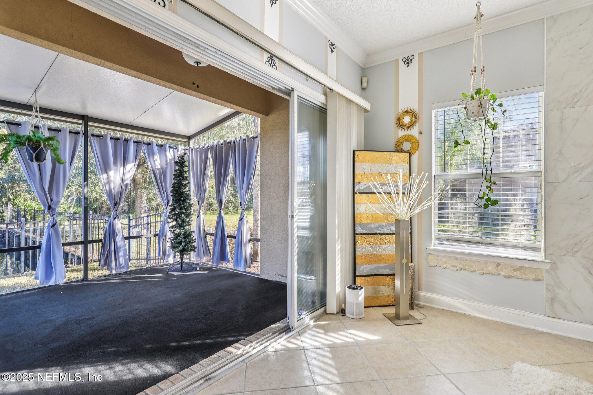 1693 Sanctuary Way Fleming Island, FL 32003 - Photo 7 of 33 a view of an entryway with wooden floor