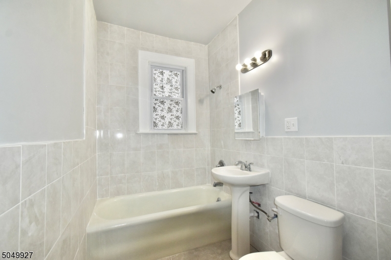 519 Clinton Place, Unit 2R Newark, NJ 07112 - Photo 11 of 15 a bathroom with a sink a toilet and shower