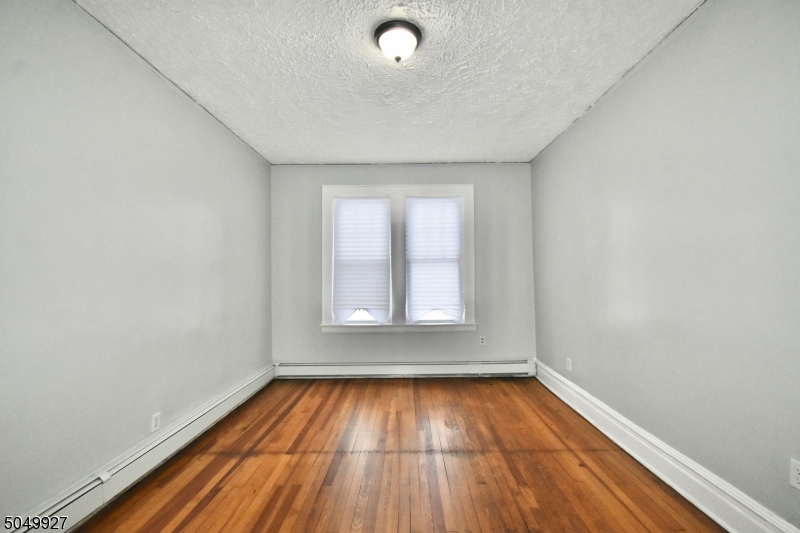 519 Clinton Place, Unit 2R Newark, NJ 07112 - Photo 12 of 15 a view of empty room with wooden floor and fan