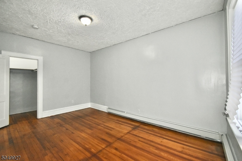 519 Clinton Place, Unit 2R Newark, NJ 07112 - Photo 13 of 15 a view of empty room with wooden floor