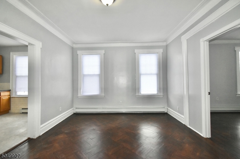519 Clinton Place, Unit 2R Newark, NJ 07112 - Photo 3 of 15 an empty room with wooden floor and windows