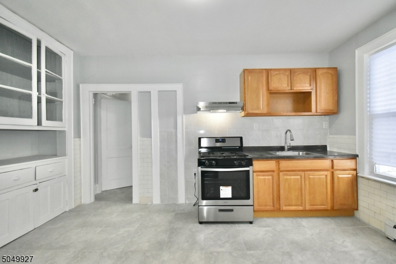 519 Clinton Place, Unit 2R Newark, NJ 07112 - Photo 5 of 15 a kitchen with stainless steel appliances granite countertop a stove a sink and a refrigerator