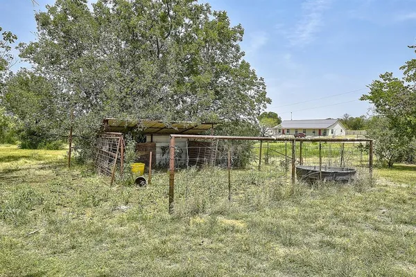 a view of outdoor space with green field and trees