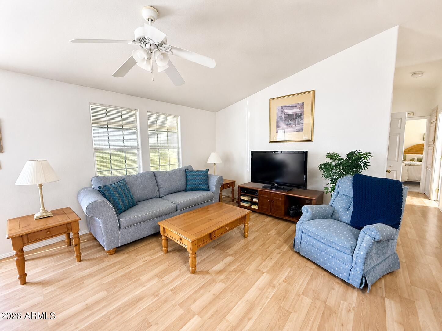8865 East Baseline Road, Unit 103 Mesa, AZ 85209 - Photo 2 of 47 a living room with furniture and a flat screen tv