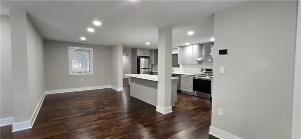 a view of kitchen with wooden floor and electronic appliances