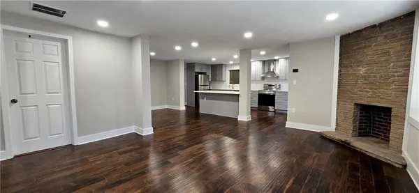 a view of kitchen with livingroom and fireplace