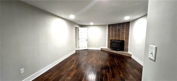 a view of a room with wooden floor and windows