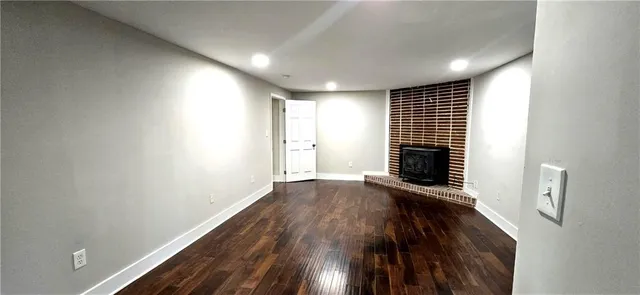 a view of a room with wooden floor and windows