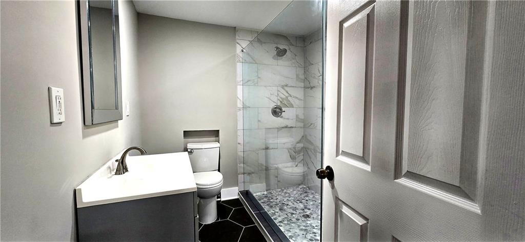 3594 Abbotts Bridge Road Duluth, GA 30096 - Photo 17 of 30 a bathroom with a sink a toilet and shower