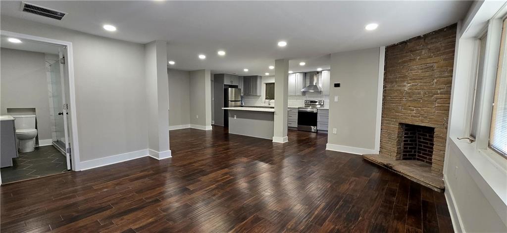 3594 Abbotts Bridge Road Duluth, GA 30096 - Photo 20 of 30 a living room with stainless steel appliances furniture a fireplace and wooden floor