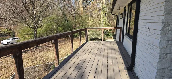 a view of balcony with wooden floor and fence