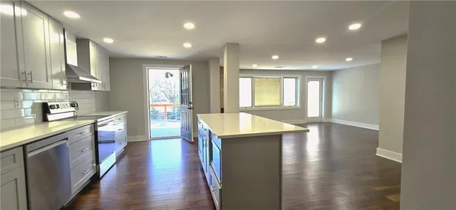 a kitchen with counter top space and wooden floor