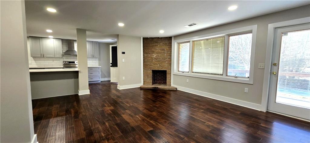 3594 Abbotts Bridge Road Duluth, GA 30096 - Photo 8 of 30 a view of an empty room with wooden floor and a window