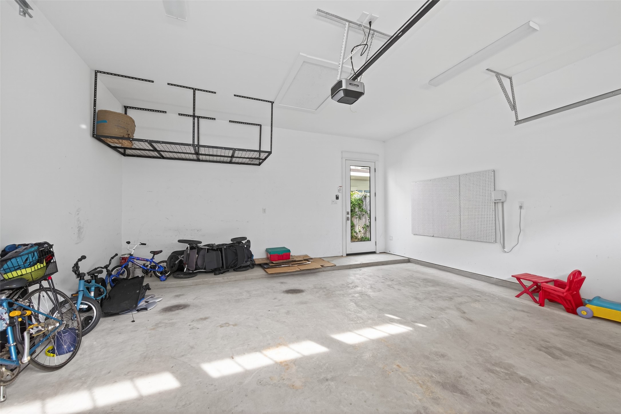 515 West 25th Street, Unit 1 Houston, TX 77008 - Photo 33 of 44 18’4” x 20’6” 2 car detached garage features peg board, and fast track system with hooks.