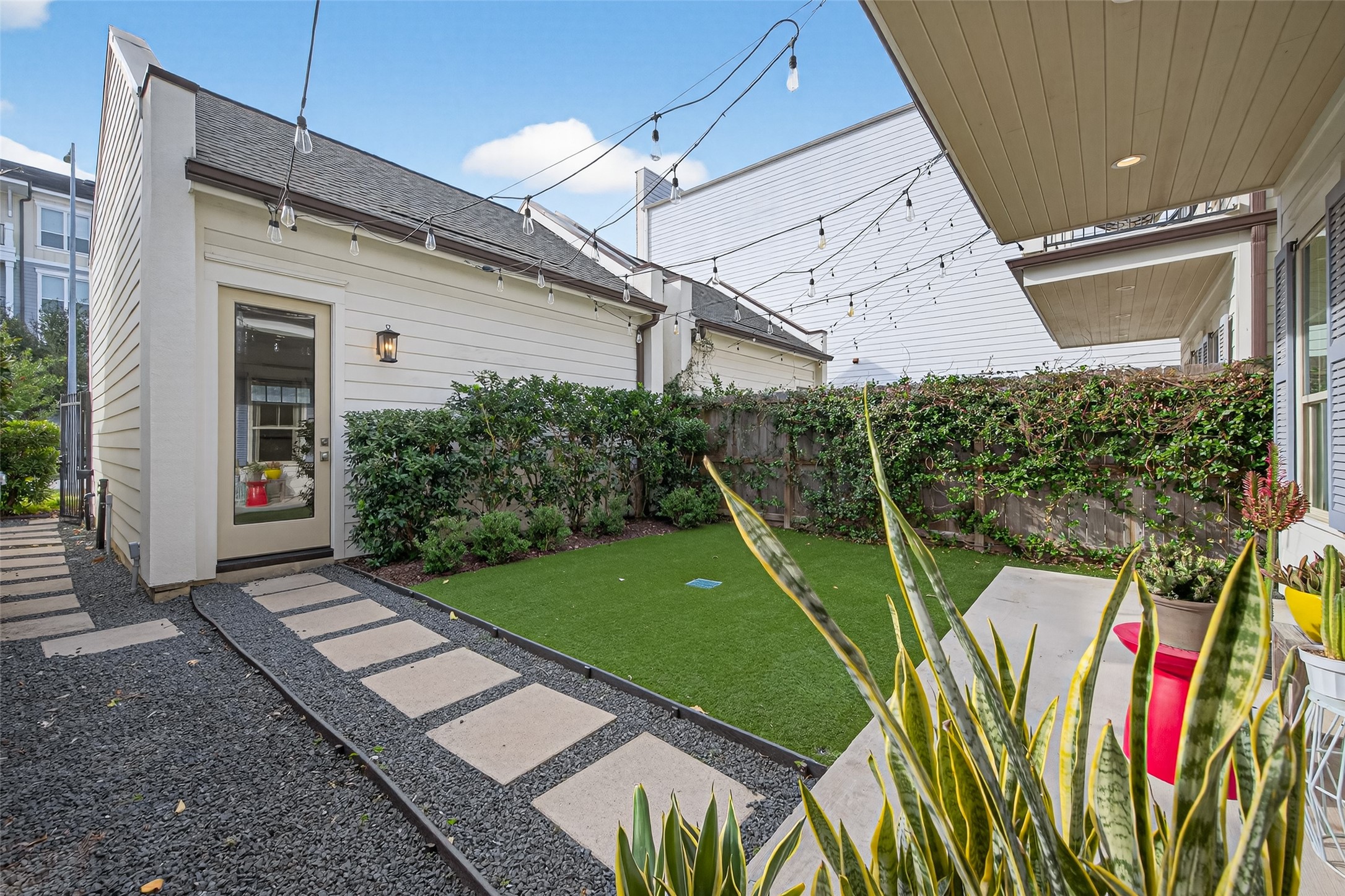 515 West 25th Street, Unit 1 Houston, TX 77008 - Photo 4 of 44 Front yard offers direct access to the detached 2-car garage and features a charming outdoor setting; with two separate yard spaces this is the ideal for kids to play and enjoy.