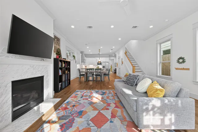 a large kitchen with stainless steel appliances kitchen island granite countertop a sink and a large refrigerator