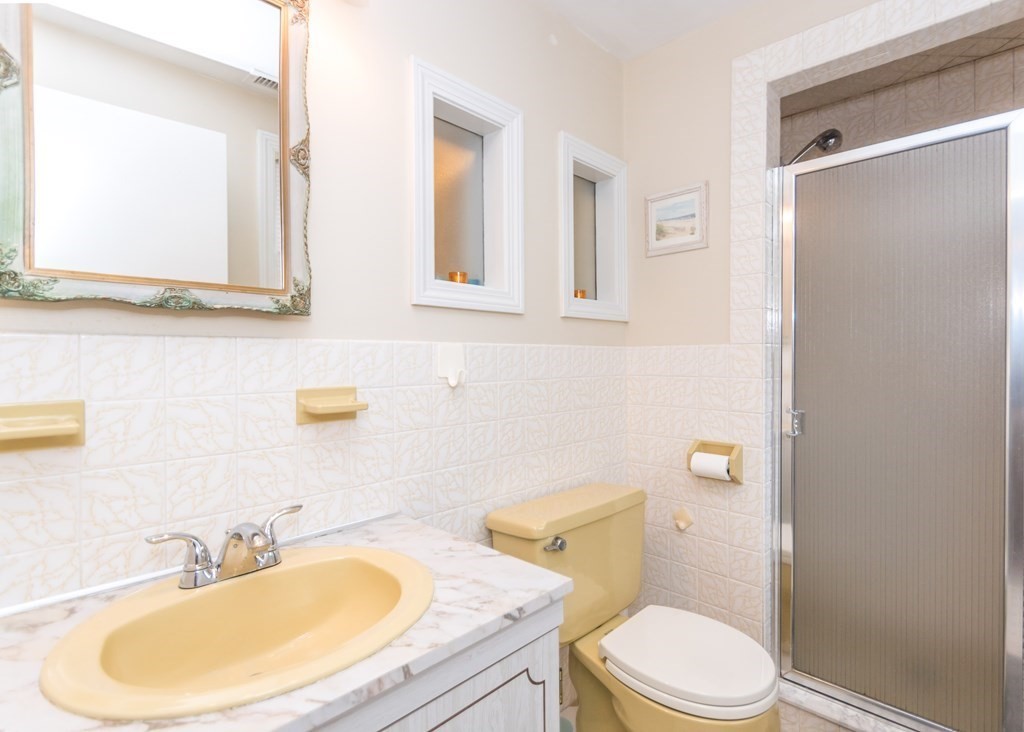 43 Alfreton Road Needham, MA 02494 - Photo 19 of 34 a bathroom with a sink a toilet and a mirror