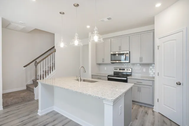a kitchen with kitchen island a sink and appliances