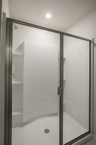 a bathroom with a glass shower door