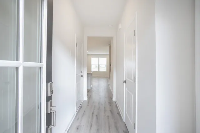 a view of a hallway with wooden floor