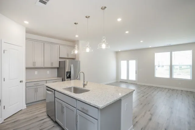 a kitchen with a sink window and cabinets