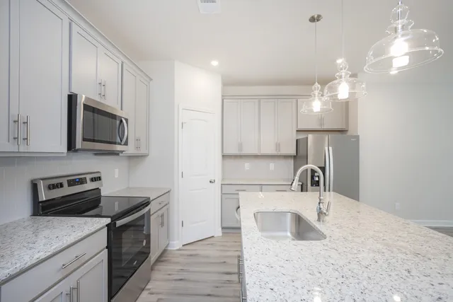 a kitchen with a sink a stove and microwave