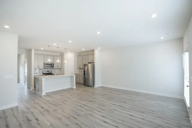 a large kitchen with a lot of counter top space and refrigerator