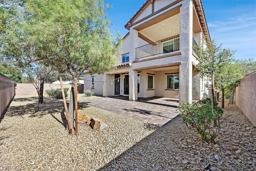 1106 Langston Ranch Avenue Henderson, NV 89002 - Photo 34 of 36 A spacious backyard with a paver patio and ample room for outdoor living.