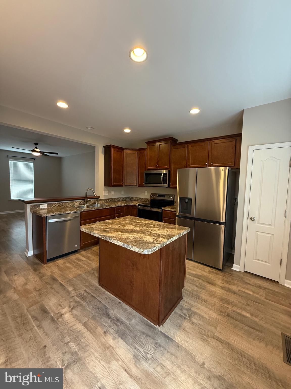 23 Landis Court Falling Waters, WV 25419 - Photo 10 of 45 a kitchen with stainless steel appliances granite countertop a stove top oven a refrigerator and a sink