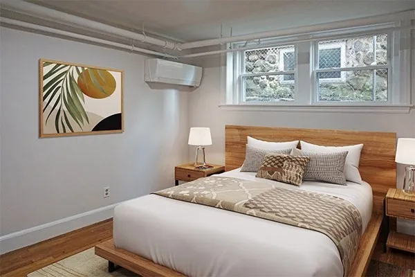 a bedroom with a bed and a painting on the wall