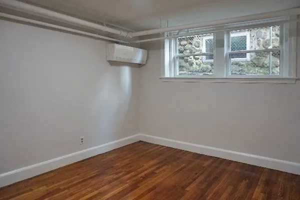 a view of a room with wooden floor and windows
