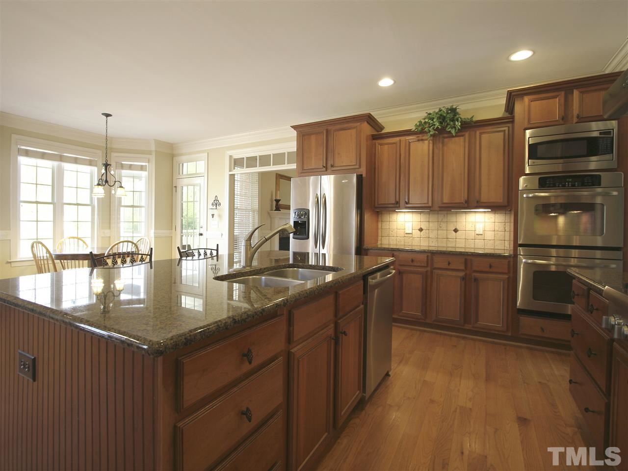 1205 Verde Farm Road Raleigh, NC 27603 - Photo 13 of 25 View from kitchen toward the breakfast room. Note the staggered-height cabinets.