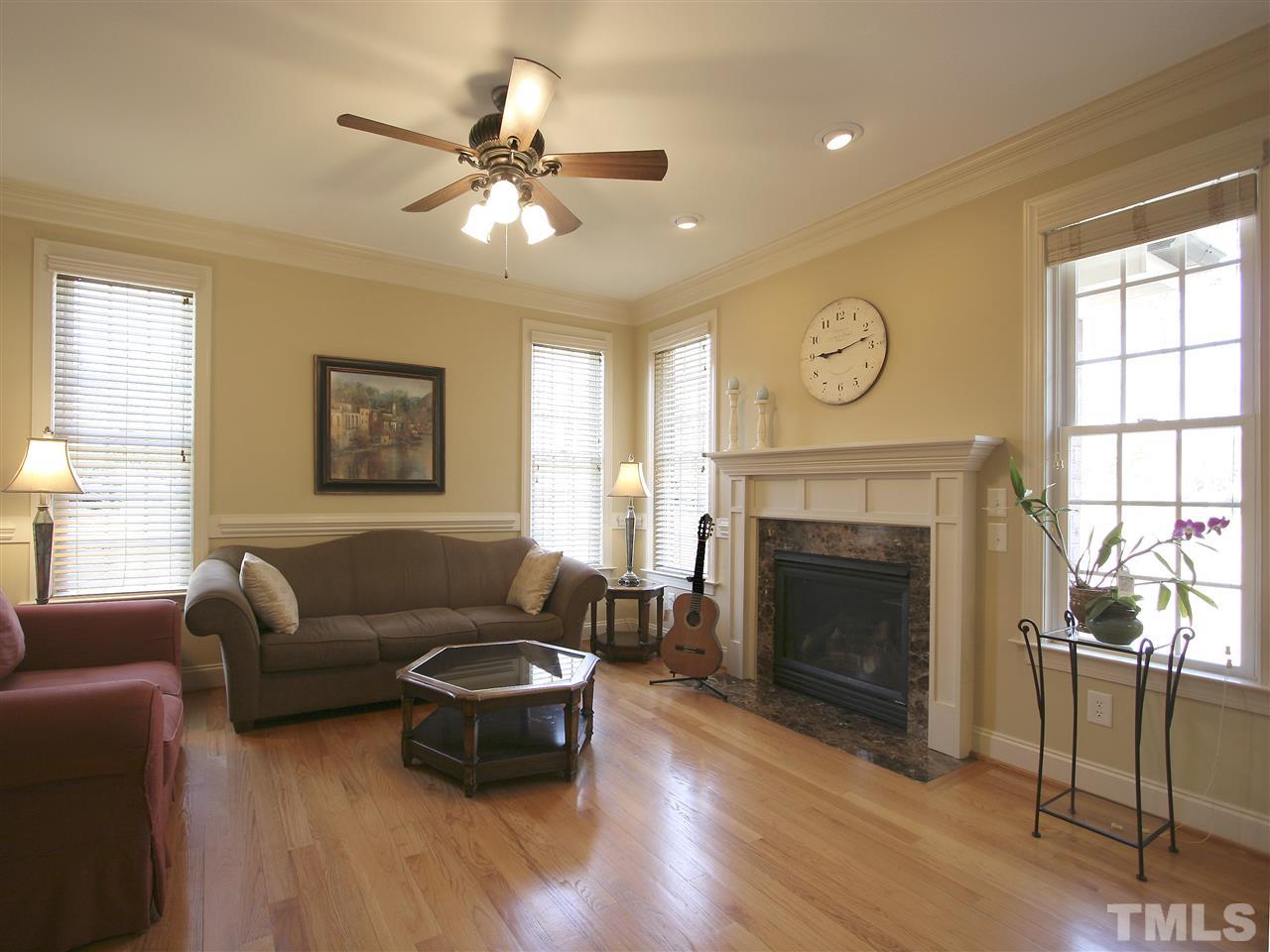 1205 Verde Farm Road Raleigh, NC 27603 - Photo 16 of 25 Family room has cozy gas-log fireplace, hardwood floor, recessed lighting and a ceiling fan with light. Chair rail. Lots of windows. Hardwood floor.