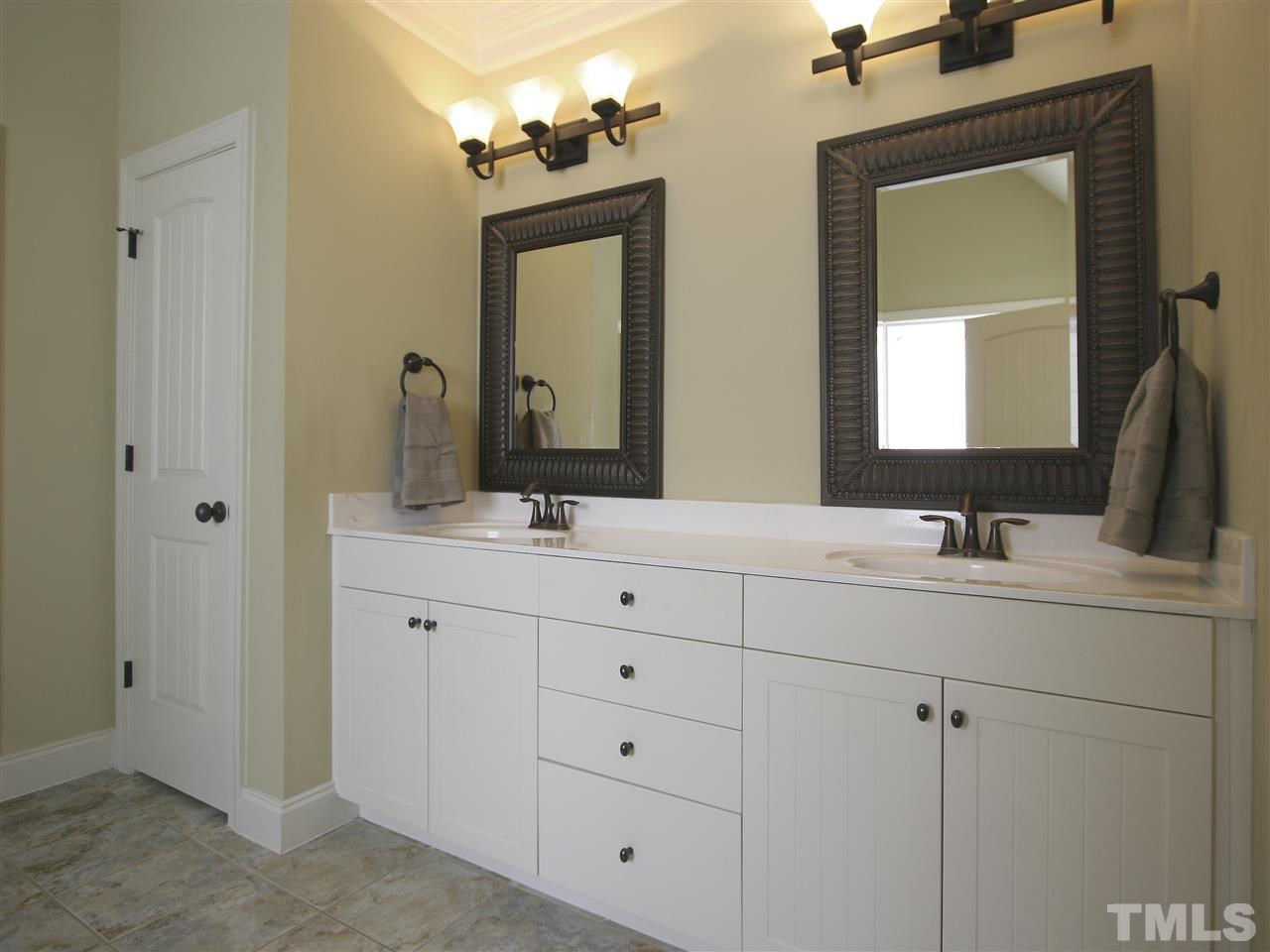 1205 Verde Farm Road Raleigh, NC 27603 - Photo 19 of 25 Master bath has craftsman dual-sink vanity with bronze fixtures, tile floor and framed mirrors.