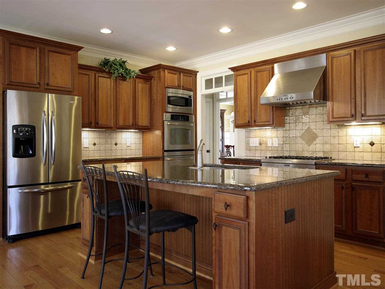 1205 Verde Farm Road Raleigh, NC 27603 - Photo 10 of 25 Kitchen island is a wonderful space for food prep, homework, entertaining, or your more informal meals.