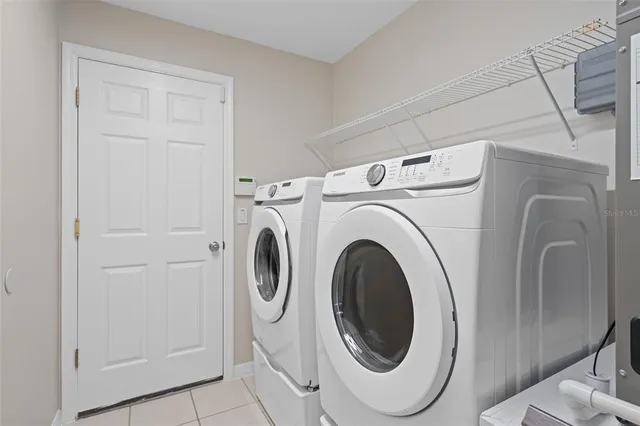an empty room with closet and a chandelier fan