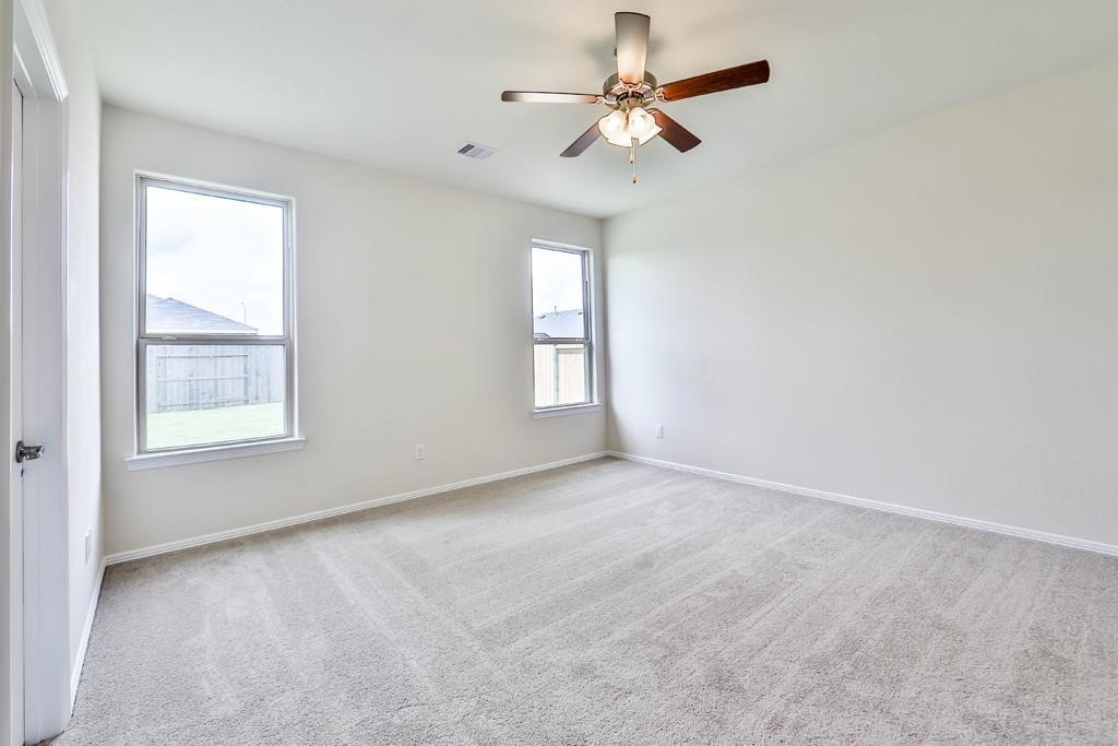 247 Sintra Lk Way Rosenberg, TX 77469 - Photo 14 of 28 an empty room with windows and fan