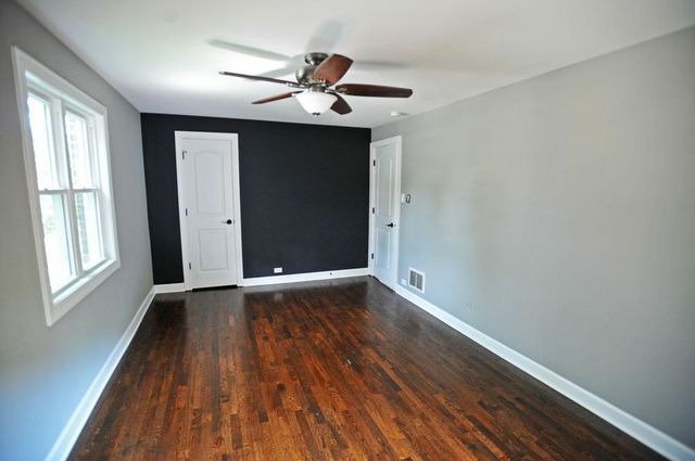2633 West 99th Street Chicago, IL 60655 - Photo 12 of 17 a view of empty room with wooden floor and fan