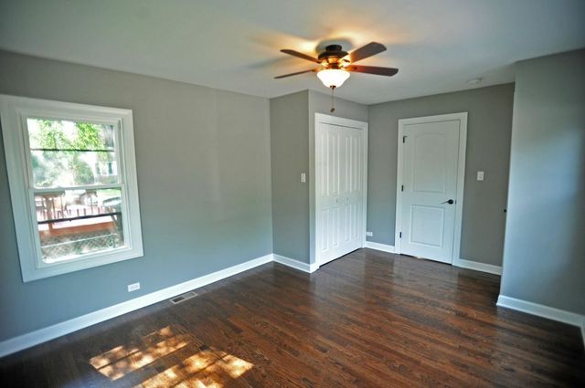 2633 West 99th Street Chicago, IL 60655 - Photo 13 of 17 a view of an empty room with wooden floor and a window