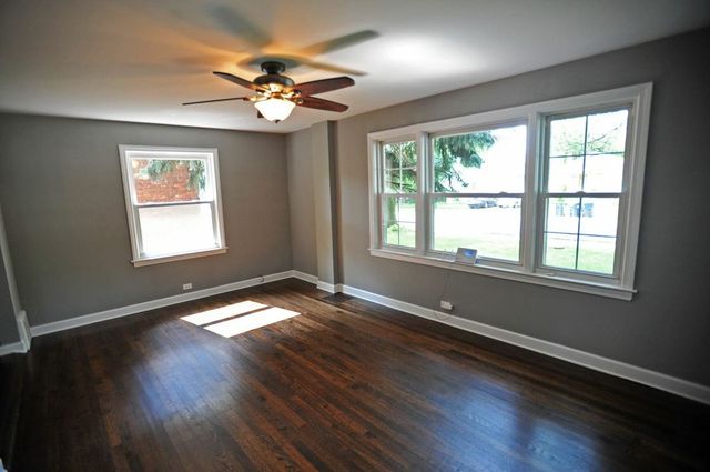 2633 West 99th Street Chicago, IL 60655 - Photo 3 of 17 a view of an empty room with wooden floor and a window