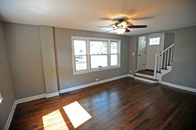 2633 West 99th Street Chicago, IL 60655 - Photo 4 of 17 a view of an empty room with wooden floor and a window