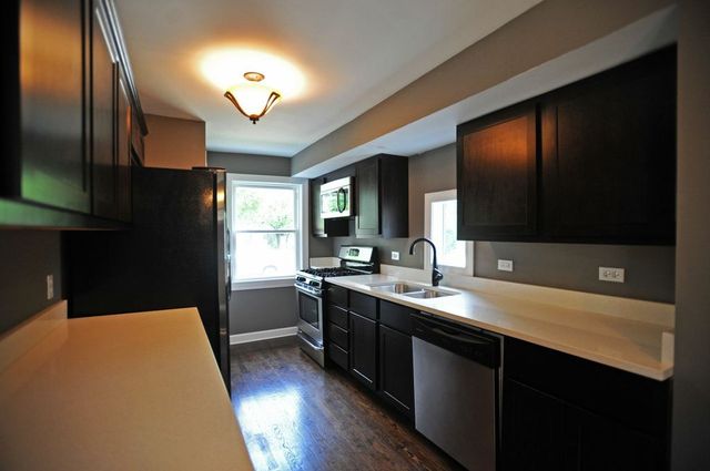 2633 West 99th Street Chicago, IL 60655 - Photo 5 of 17 a kitchen with a sink appliances and cabinets