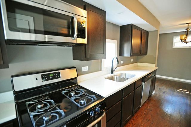 2633 West 99th Street Chicago, IL 60655 - Photo 6 of 17 a kitchen with a stove and a sink