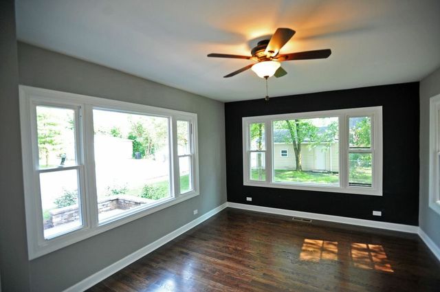 2633 West 99th Street Chicago, IL 60655 - Photo 7 of 17 a view of an empty room with wooden floor and a window