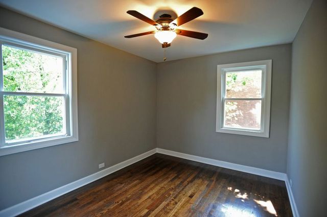 2633 West 99th Street Chicago, IL 60655 - Photo 9 of 17 a view of an empty room with window and wooden floor