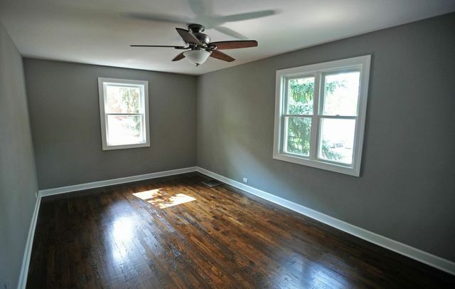 2633 West 99th Street Chicago, IL 60655 - Photo 10 of 17 a view of an empty room with wooden floor and a window