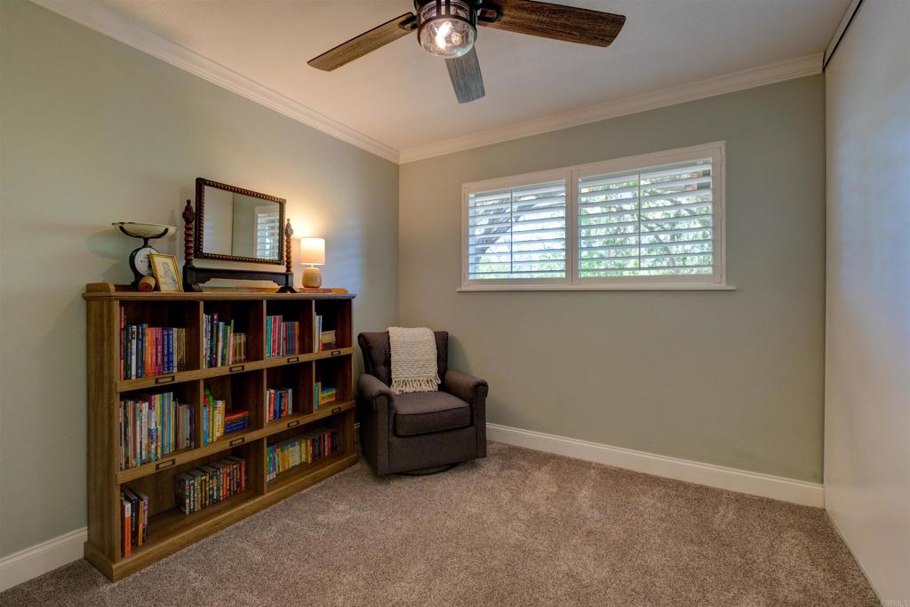 8942 Fletcher Valley Dr. Santee, CA 92071 - Photo 14 of 32 a living room with furniture and a book shelf