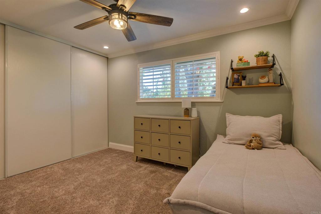 8942 Fletcher Valley Dr. Santee, CA 92071 - Photo 16 of 32 a bedroom with a bed and window