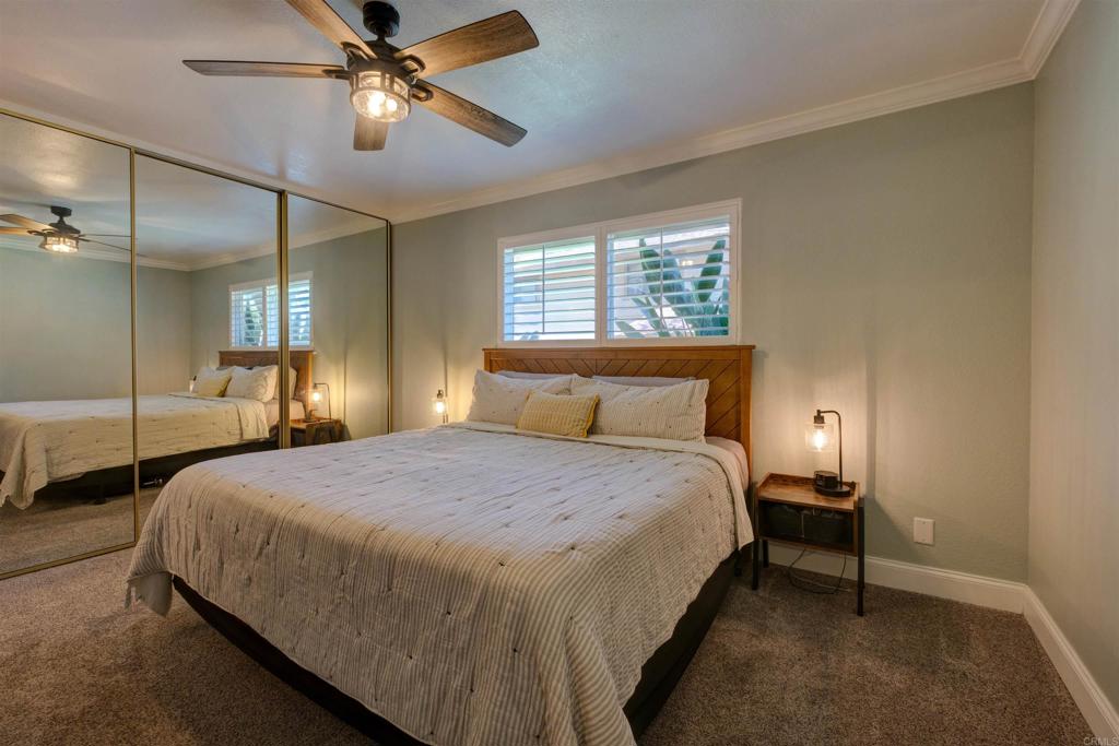 8942 Fletcher Valley Dr. Santee, CA 92071 - Photo 17 of 32 a bedroom with a bed and a chandelier