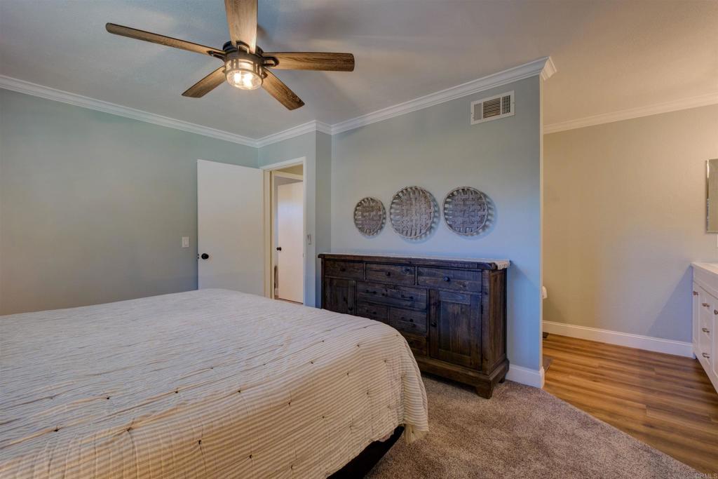 8942 Fletcher Valley Dr. Santee, CA 92071 - Photo 18 of 32 a bed room with a bed and a fireplace